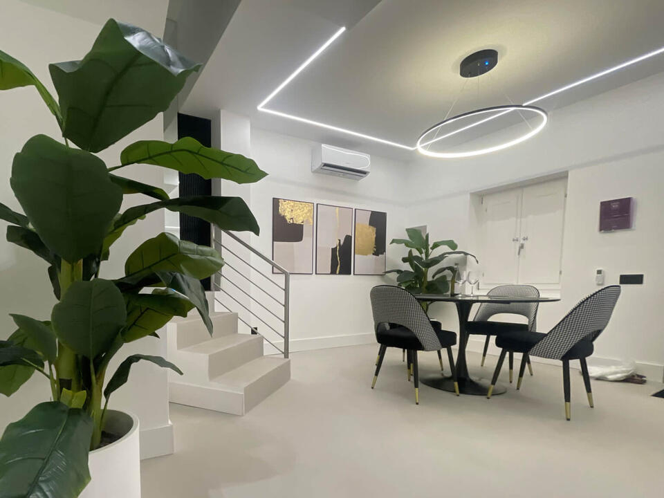 Spacious designer living room in Olbia holiday home with large smart TV, stylish decor, and modern seating
